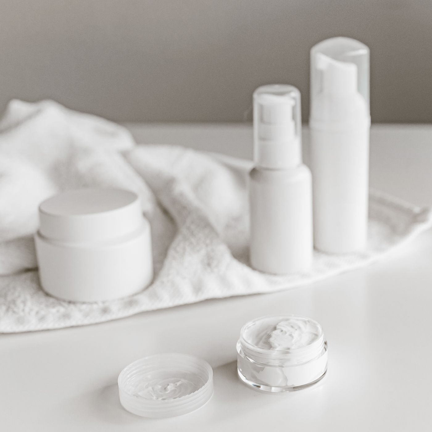 Elarin skincare bottles and jars arranged on a white surface